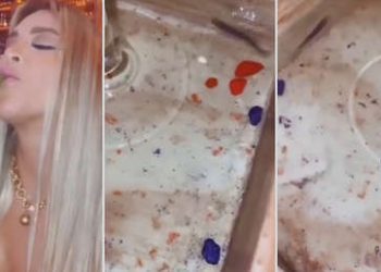 Una modelo peruana toma un cóctel decorado con un pez vivo